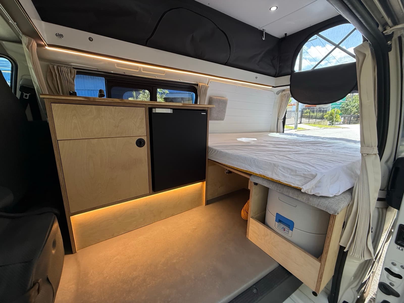 MANA interior with pop top, fridge and bed